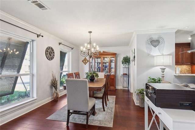 dining area with visible vents, baseboards, dark wood finished floors, ornamental molding, and a notable chandelier