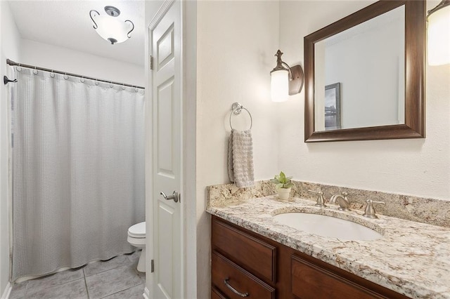 bathroom featuring tile patterned floors, toilet, a shower with shower curtain, and vanity