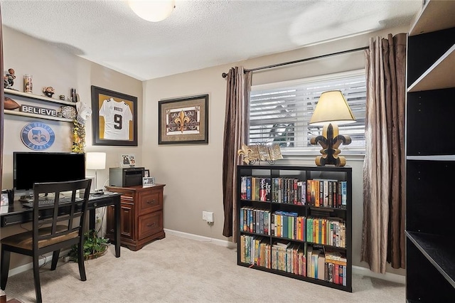 carpeted home office featuring baseboards and a textured ceiling