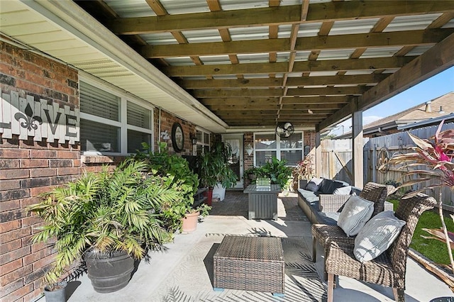 view of patio featuring an outdoor living space and fence