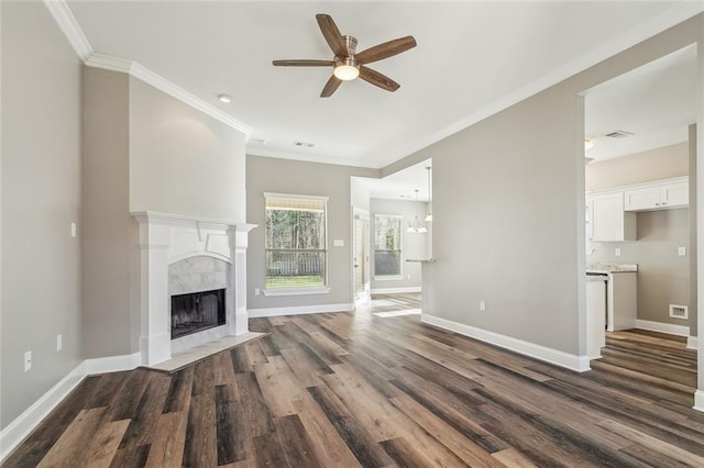 unfurnished living room with a fireplace, dark wood-type flooring, baseboards, and ornamental molding