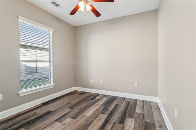 unfurnished room featuring ceiling fan, wood finished floors, visible vents, and baseboards