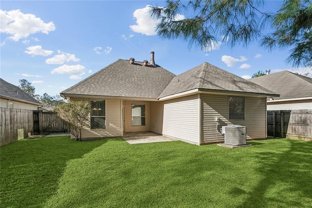 back of property with a patio, central air condition unit, a yard, and a fenced backyard