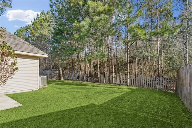 view of yard with cooling unit and a fenced backyard