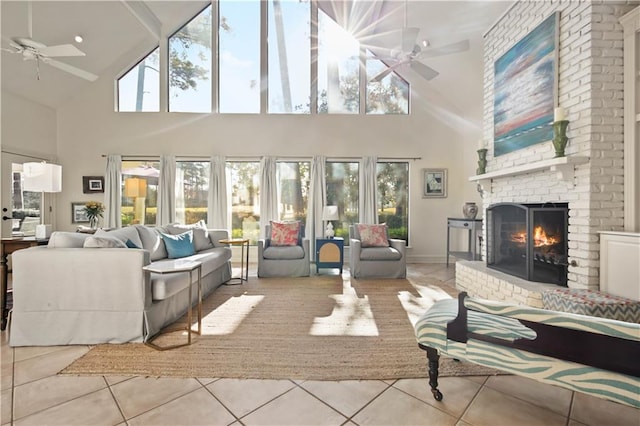 tiled living room with high vaulted ceiling, a brick fireplace, and ceiling fan