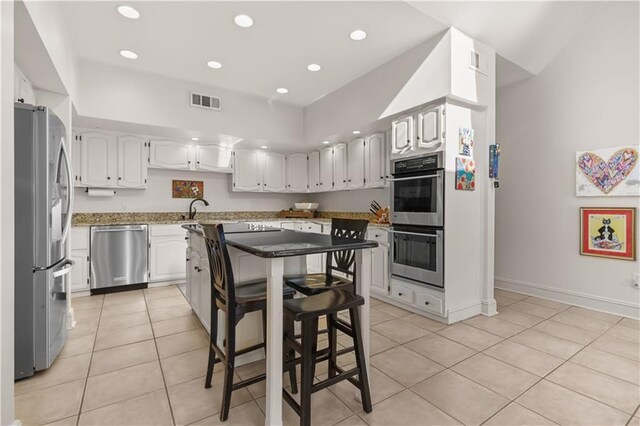 kitchen with light tile patterned floors, visible vents, recessed lighting, stainless steel appliances, and white cabinets