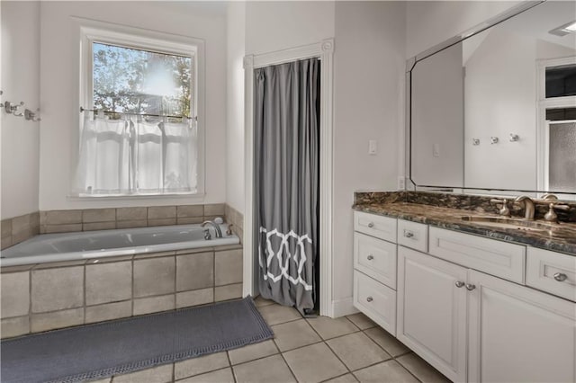 full bathroom with tile patterned flooring, vanity, and a garden tub