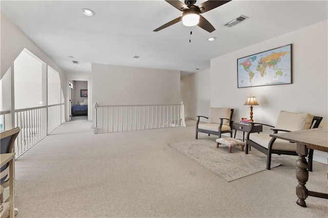 living area with visible vents, recessed lighting, and carpet