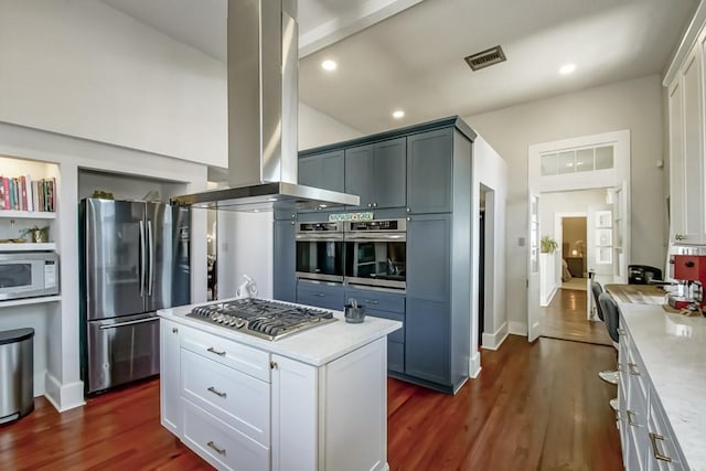 kitchen with visible vents, appliances with stainless steel finishes, island exhaust hood, dark wood-style floors, and white cabinets