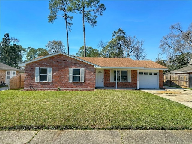 ranch-style home with a front lawn, an attached garage, driveway, and fence