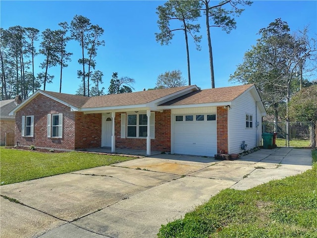 ranch-style house featuring driveway, a front lawn, a gate, an attached garage, and brick siding