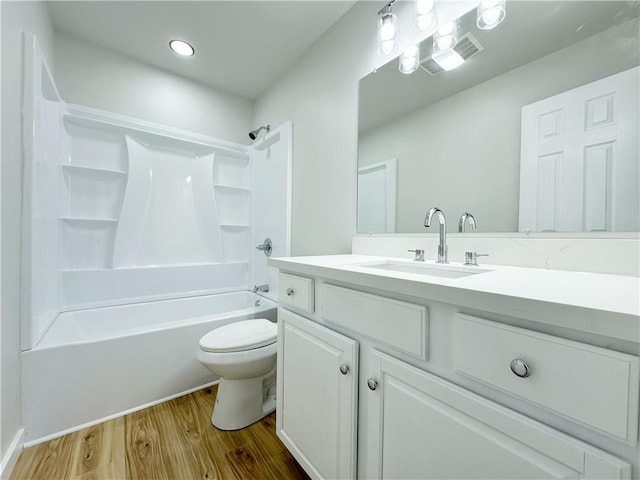 bathroom featuring vanity, shower / bathing tub combination, toilet, and wood finished floors