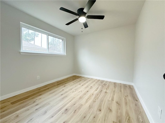 empty room featuring light wood finished floors, ceiling fan, and baseboards