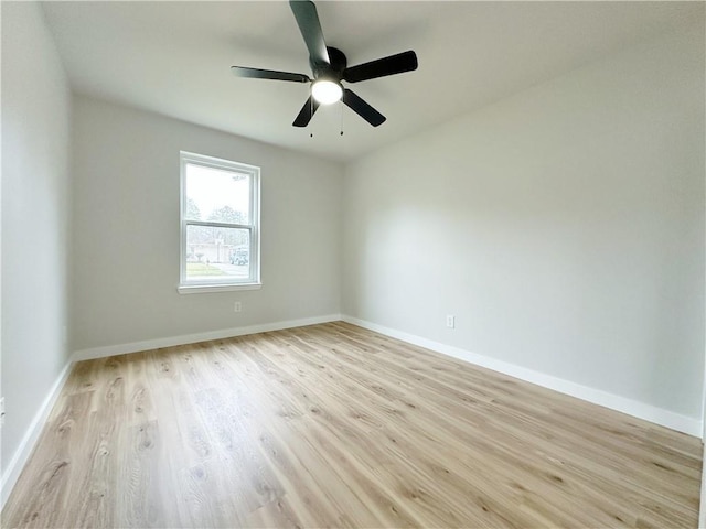 unfurnished room with a ceiling fan, baseboards, and light wood finished floors