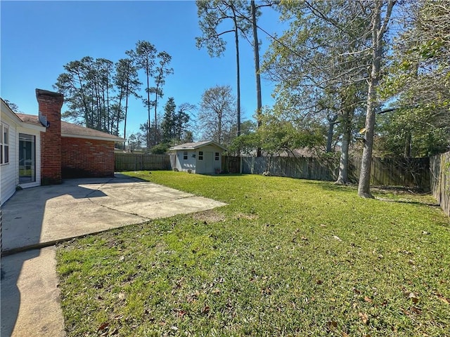 view of yard with a patio, an outdoor structure, and a fenced backyard