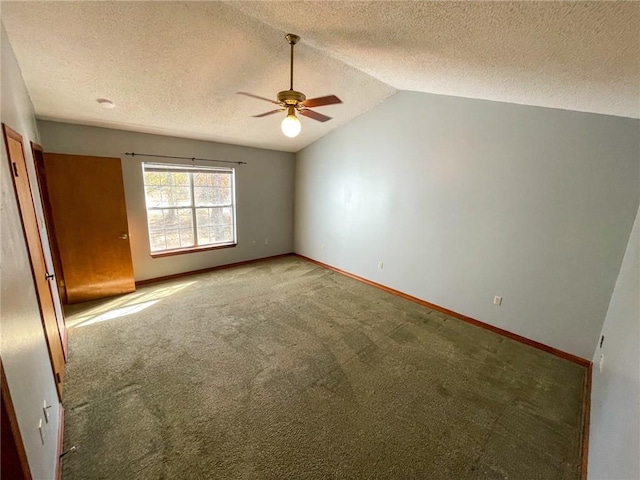 unfurnished room featuring light colored carpet, baseboards, lofted ceiling, and a ceiling fan