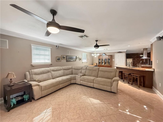 living room with visible vents, baseboards, ceiling fan, and ornamental molding