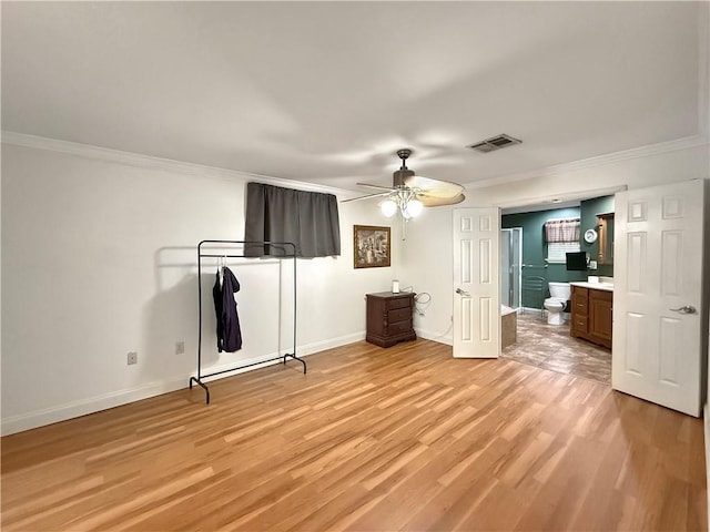 unfurnished bedroom with visible vents, ensuite bath, crown molding, light wood finished floors, and baseboards