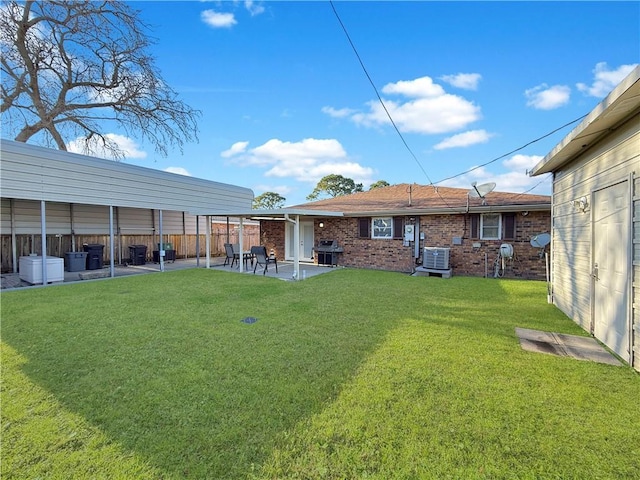 view of yard with central AC unit, a patio, and fence