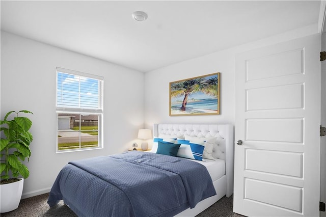 carpeted bedroom featuring baseboards