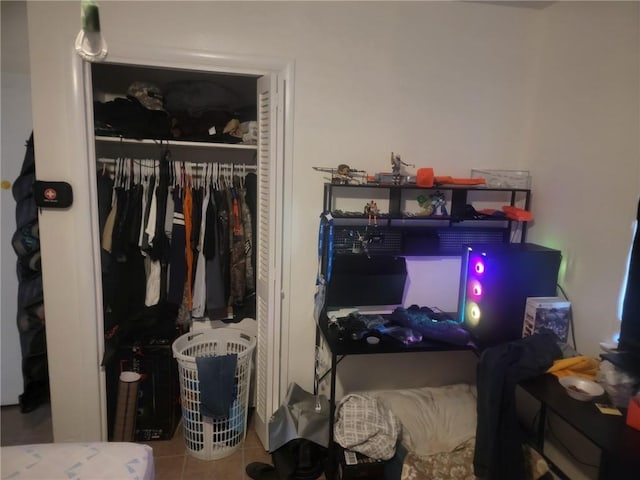 bedroom featuring tile patterned flooring and a closet