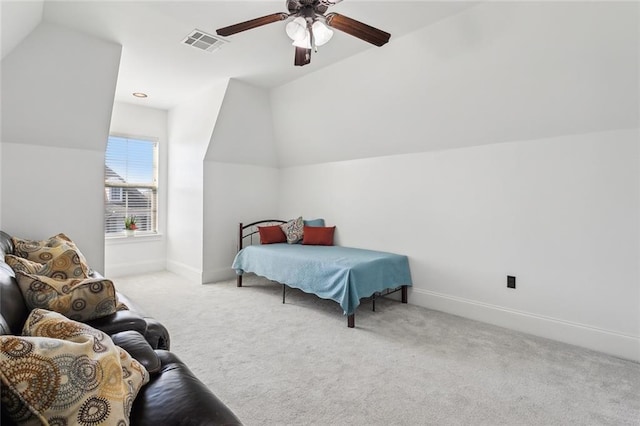 carpeted bedroom with visible vents, baseboards, and vaulted ceiling