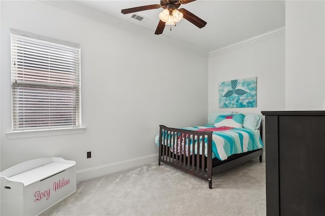 bedroom with a ceiling fan, baseboards, visible vents, carpet floors, and crown molding