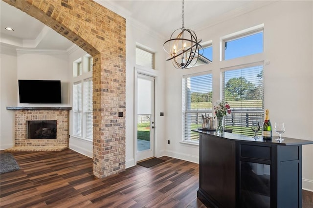 interior space featuring dark wood finished floors, a fireplace, and crown molding