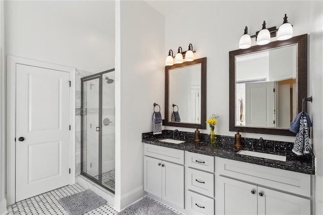 full bathroom featuring a sink, double vanity, and a shower stall