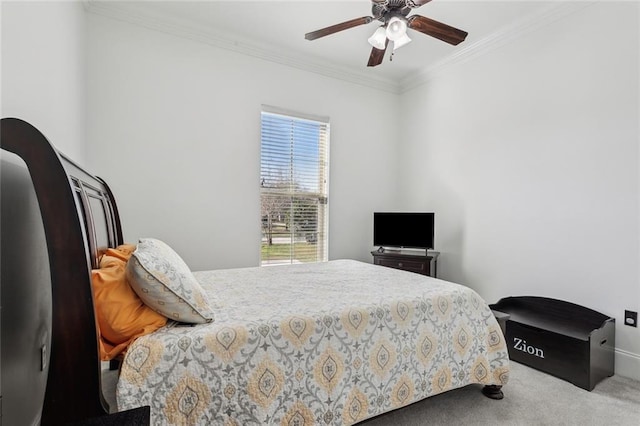 carpeted bedroom featuring crown molding and a ceiling fan