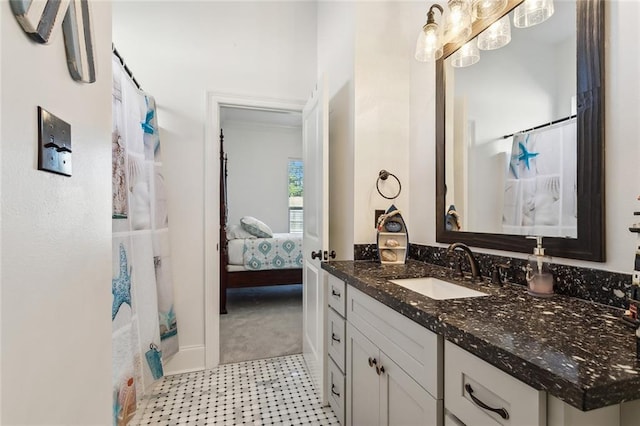 ensuite bathroom featuring curtained shower, vanity, and ensuite bathroom