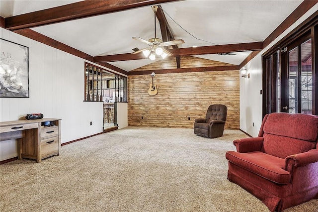 living area with wood walls, lofted ceiling with beams, a ceiling fan, and carpet floors