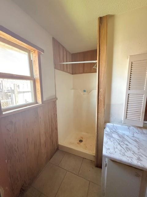 full bath with tile patterned flooring and a stall shower