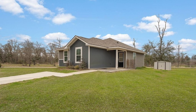 exterior space featuring an outbuilding, a storage unit, and a lawn