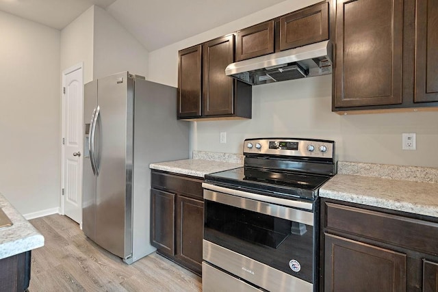 kitchen with light wood finished floors, dark brown cabinets, under cabinet range hood, light countertops, and stainless steel appliances