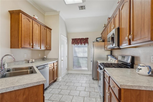 kitchen featuring visible vents, brown cabinets, appliances with stainless steel finishes, and a sink