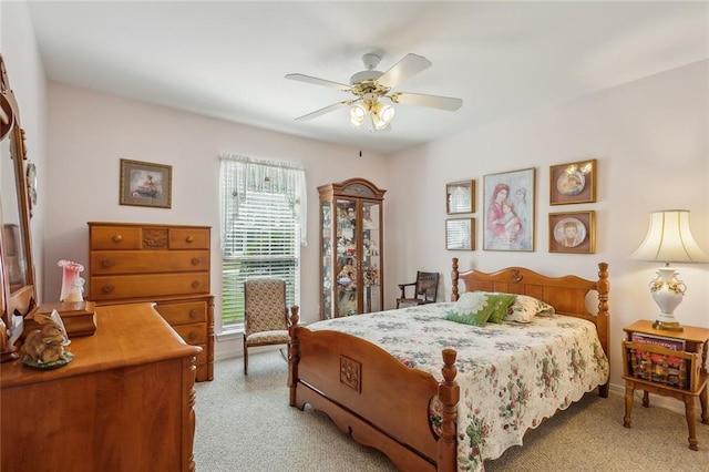 bedroom featuring baseboards, light carpet, and a ceiling fan