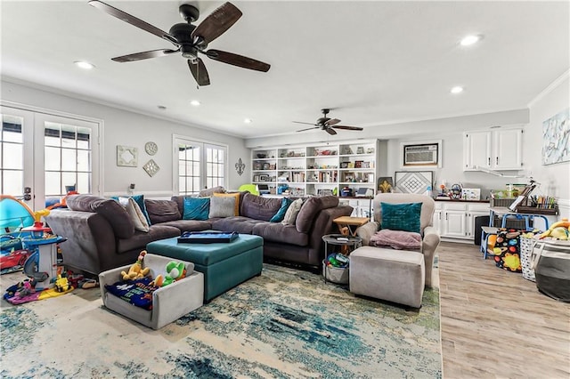 living area featuring recessed lighting, french doors, light wood-style flooring, and crown molding