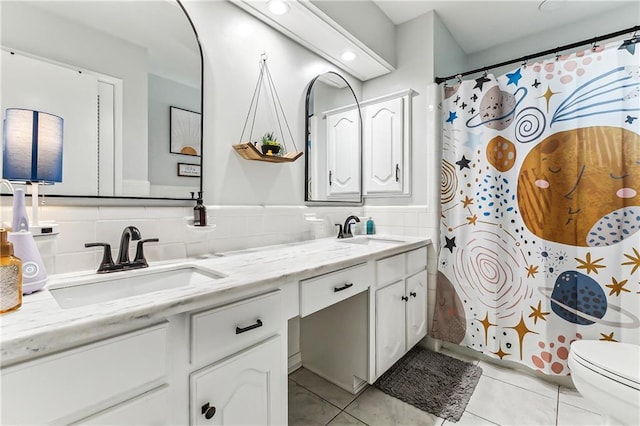 full bathroom featuring tile patterned floors, tile walls, double vanity, and a sink