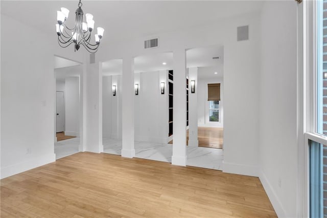 unfurnished dining area featuring visible vents, baseboards, and light wood-style floors