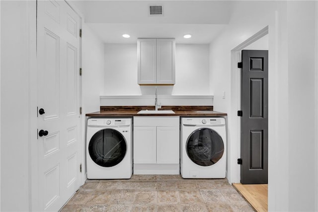 laundry room with visible vents, recessed lighting, stone finish floor, and a sink