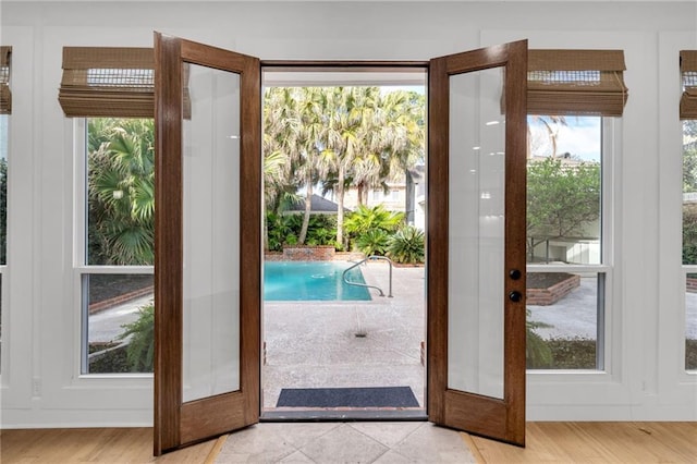 doorway featuring light wood-style flooring and french doors