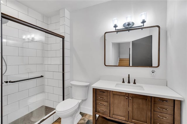 full bathroom with wood finished floors, toilet, a stall shower, and vanity