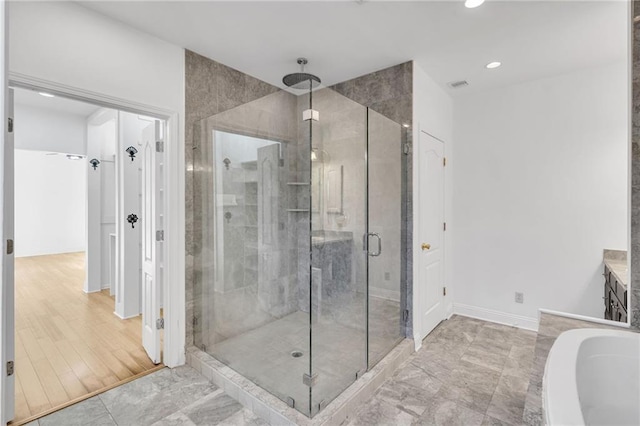 full bath with visible vents, a tub, recessed lighting, a shower stall, and baseboards