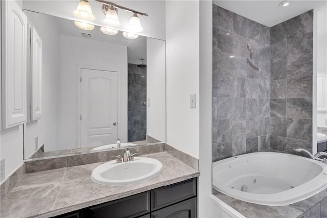 full bath featuring vanity and a whirlpool tub