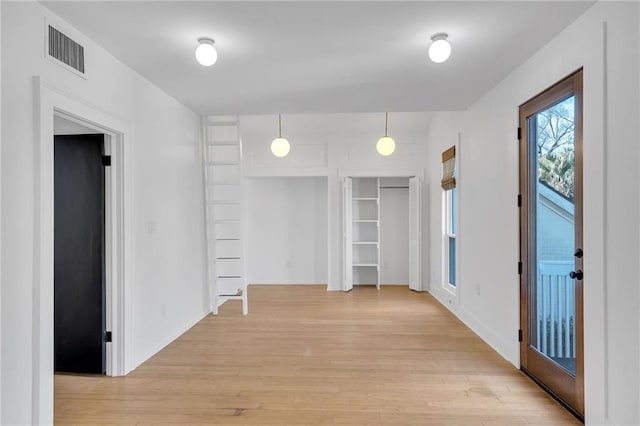 interior space with visible vents, baseboards, and light wood-style flooring