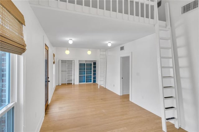 hall with visible vents and light wood-style floors