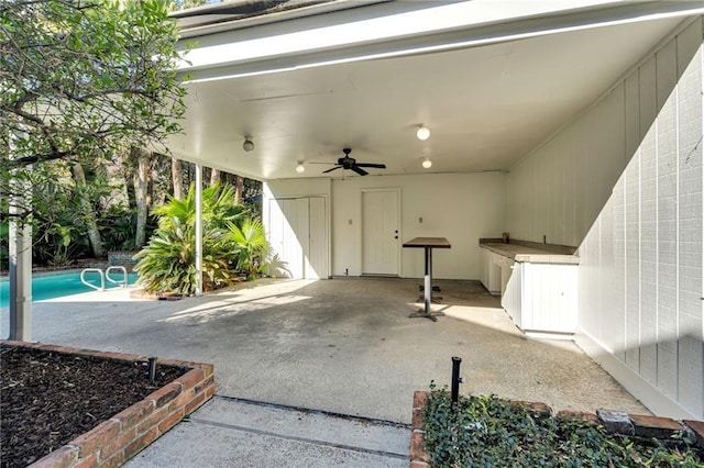 view of patio / terrace with an outdoor pool and ceiling fan