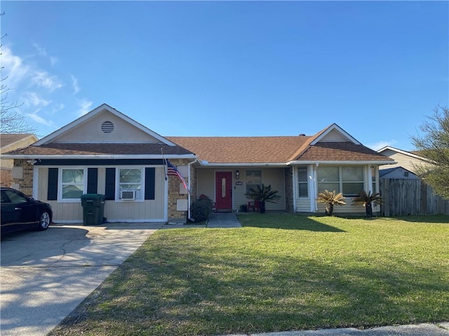 view of front of house featuring driveway, a front yard, and fence