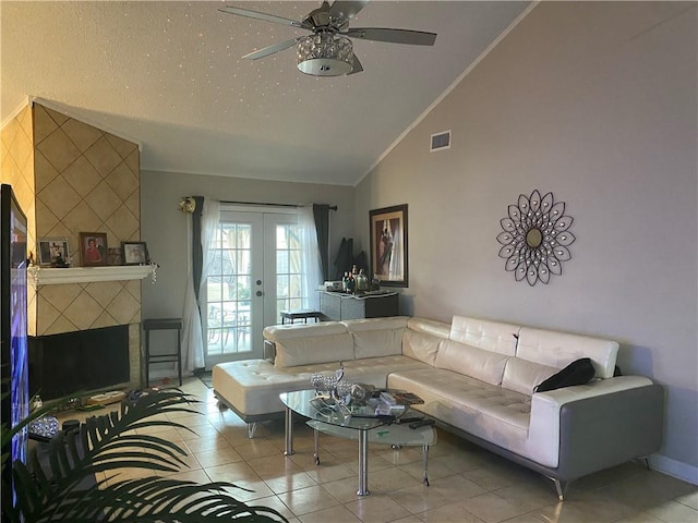 tiled living area featuring a ceiling fan, visible vents, ornamental molding, vaulted ceiling, and french doors